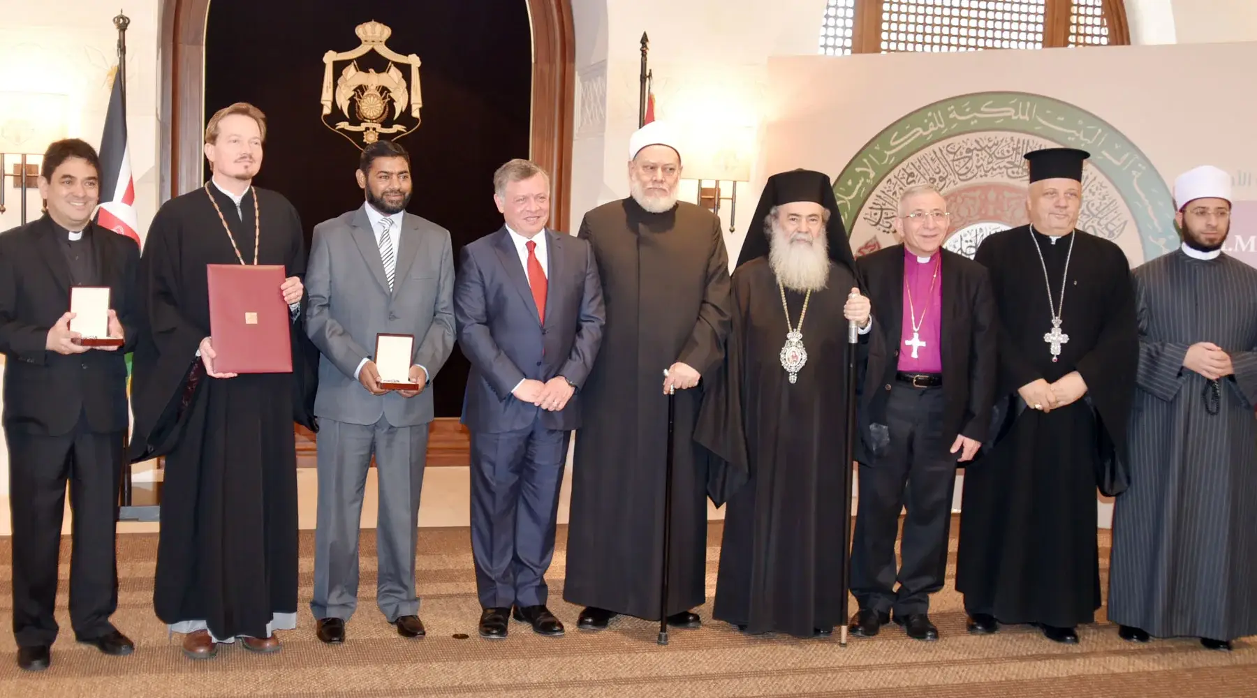 The 2016 World Interfaith Harmony Week prize ceremony: prize winners and Christian and Muslim leaders stand in a row with King Abdullah II of Jordan at the center